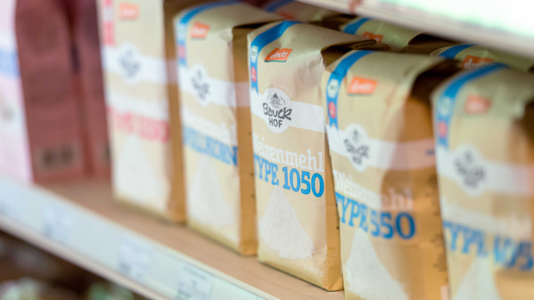 KI generiert: Verpackungen von Weizenmehl im Regal. Text: "Bauck Hof Weizenmehl Type 1050".